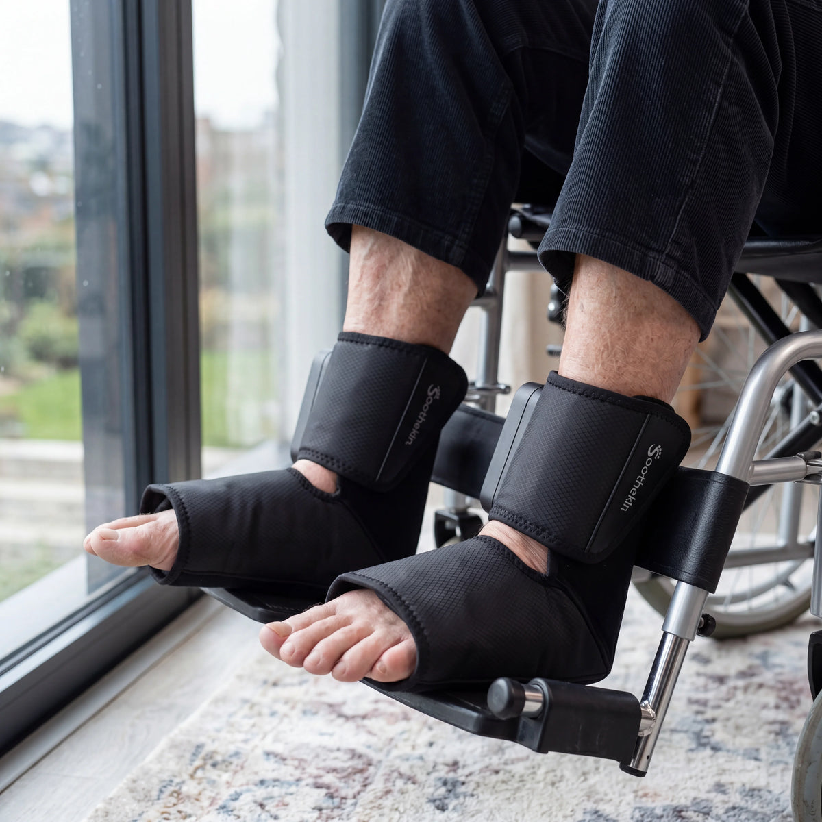 Person in wheelchair using Soothekin foot and ankle massager for comfort